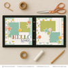Hello World Blue scrapbook page kit shown in a memory album binder mockup with the finished two-page layout. A coordinated way to preserve newborn memories and favorite photos.