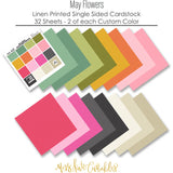 May Flowers Cardstock, papers spread out image, showing 12x12 printed smooth cardstock for scrapbook page bases, photo mats, card making, die cutting, titles, borders, and layered paper projects. Buyer theme: Spring Floral Pink & Green Printed Cardstock. May Flowers Printed Smooth Cardstock in sixteen coordinating pink, green, yellow, orange, cream and charcoal linen-look colors. Color palette includes Rose pink, coral, blush, sage green, mint, yellow, orange, cream and charcoal