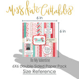 Be My Valentine 6x6 Double-Sided Paper Pack, size guide shown in hand for scale, showing 6x6 scrapbook paper for handmade cards, mini albums, junk journals, paper layering, small-scale layouts, and coordinated paper crafts. Buyer theme: Valentine 6x6 Paper for Cards & Mini Albums. Be My Valentine 6x6 Double-Sided Paper Pack with scaled hearts, plaids, gingham, XOXO blocks, flowers, bees, mailboxes and Valentine patterns for cards and mini albums