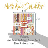 Wildflowers 6x6 Double-Sided Paper Pack, size guide shown in hand for scale, showing 6x6 scrapbook paper for handmade cards, mini albums, junk journals, paper layering, small-scale layouts, and coordinated paper crafts. Buyer theme: Floral 6x6 Scrapbook Paper for Cards & Mini Albums. Wildflowers 6x6 Double-Sided Paper Pack with scaled gingham, polka dots, berries, strawberries, meadow flowers, birds and botanical patterns for cards and mini albums